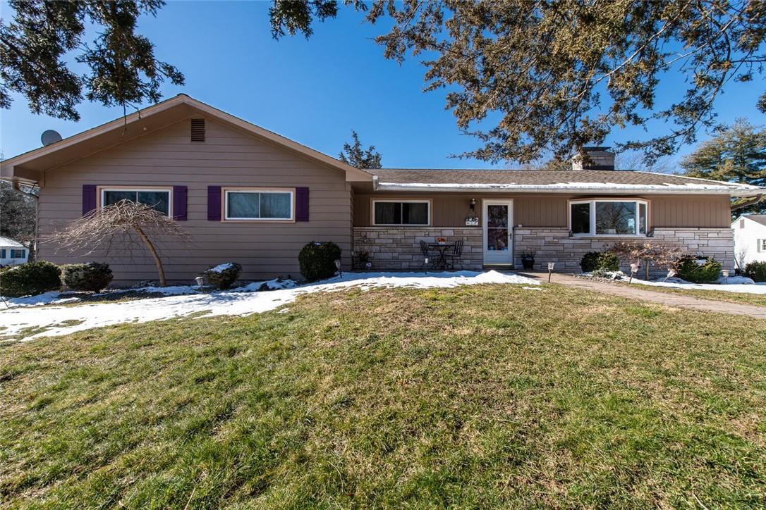 a front view of a house with yard and outdoor seating