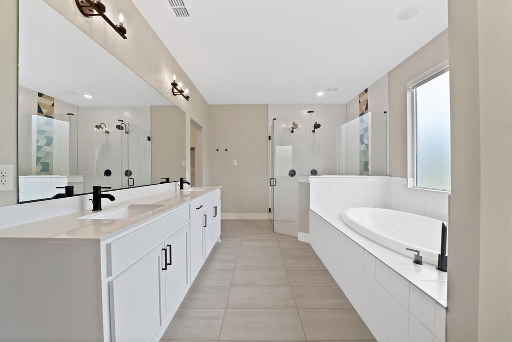 2223 Providence Way Nevada, TX 75173 - Photo 31 of 40 a large white bathroom with a double vanity sink a mirror and a bathtub