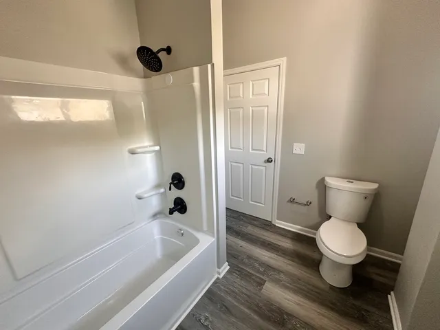 a bathroom with a toilet and a shower