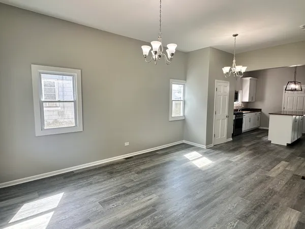 a view of a chandelier and wooden floor in a room