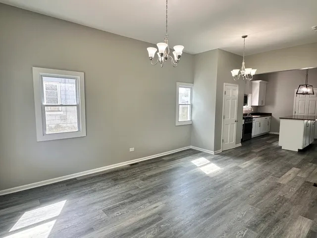 a view of a chandelier and wooden floor in a room
