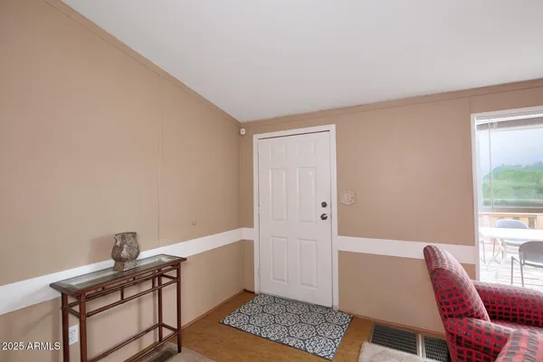 a view of a workspace with furniture and a window