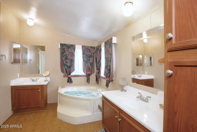 a bathroom with a sink double vanity granite and a mirror