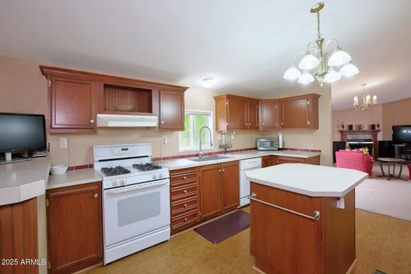 a kitchen with cabinets a sink and appliances