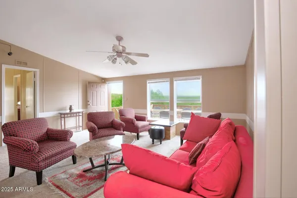 a living room with furniture and a large window