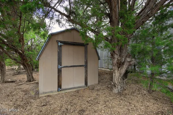 a view of a small house with a tree