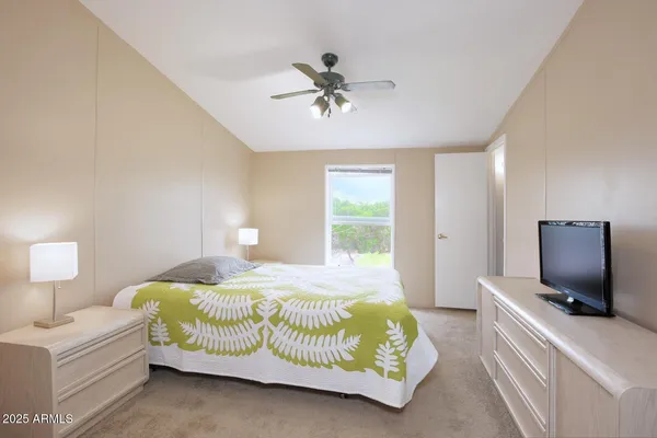 a bedroom with a bed and a flat screen tv