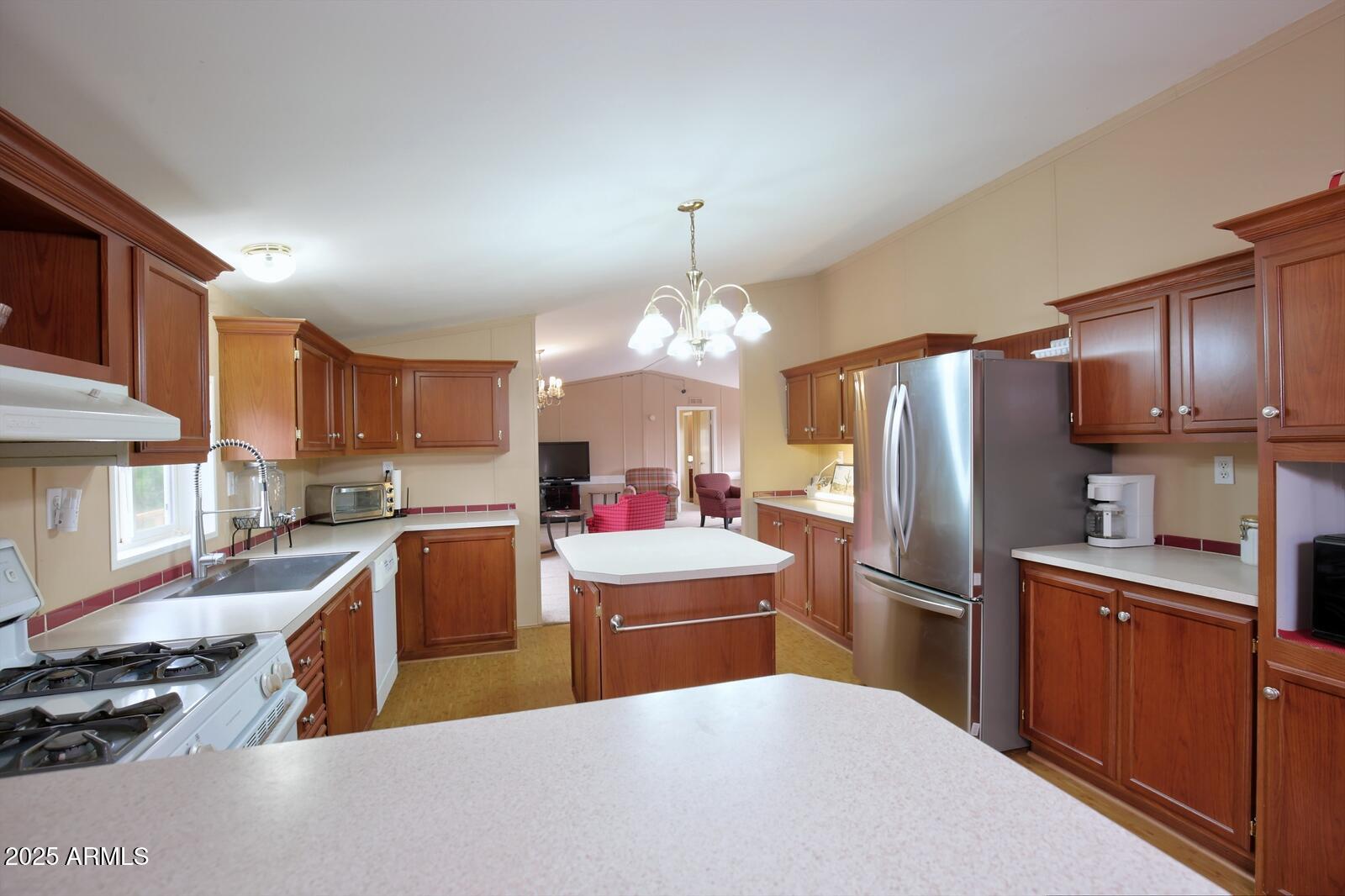 7865 Christmas Tree Road Show Low, AZ 85901 - Photo 5 of 32 a kitchen with refrigerator a sink and cabinets