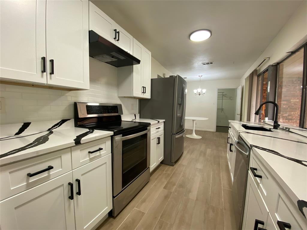 2018 Clark Trail Grand Prairie, TX 75052 - Photo 16 of 40 a kitchen with stainless steel appliances a sink stove and refrigerator