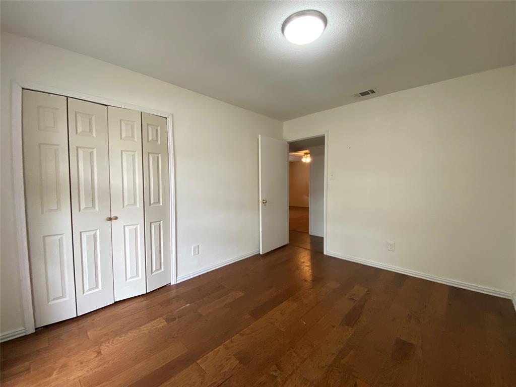 2018 Clark Trail Grand Prairie, TX 75052 - Photo 19 of 40 an empty room with wooden floor and windows