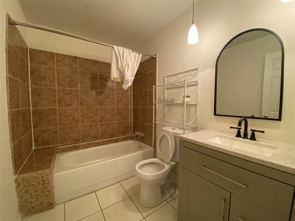 2018 Clark Trail Grand Prairie, TX 75052 - Photo 28 of 40 a bathroom with a sink toilet a mirror and shower