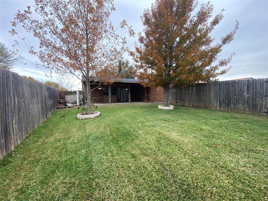 2018 Clark Trail Grand Prairie, TX 75052 - Photo 32 of 40 a view of a house with backyard and a tree