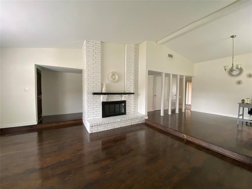 2018 Clark Trail Grand Prairie, TX 75052 - Photo 6 of 40 a view of a livingroom with wooden floor a fireplace and window