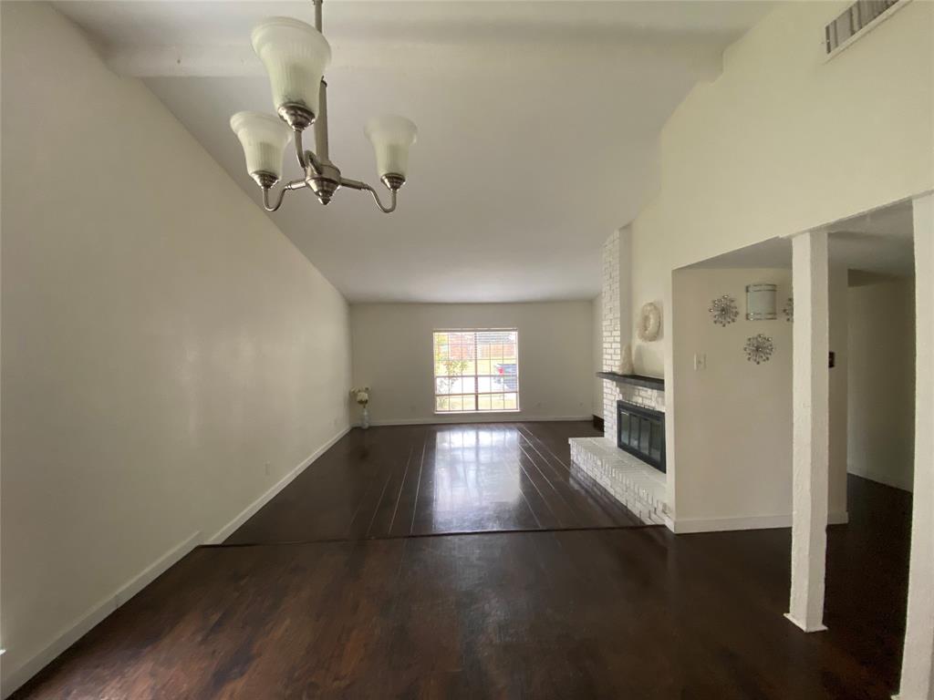 2018 Clark Trail Grand Prairie, TX 75052 - Photo 9 of 40 wooden floor in an empty room with a window