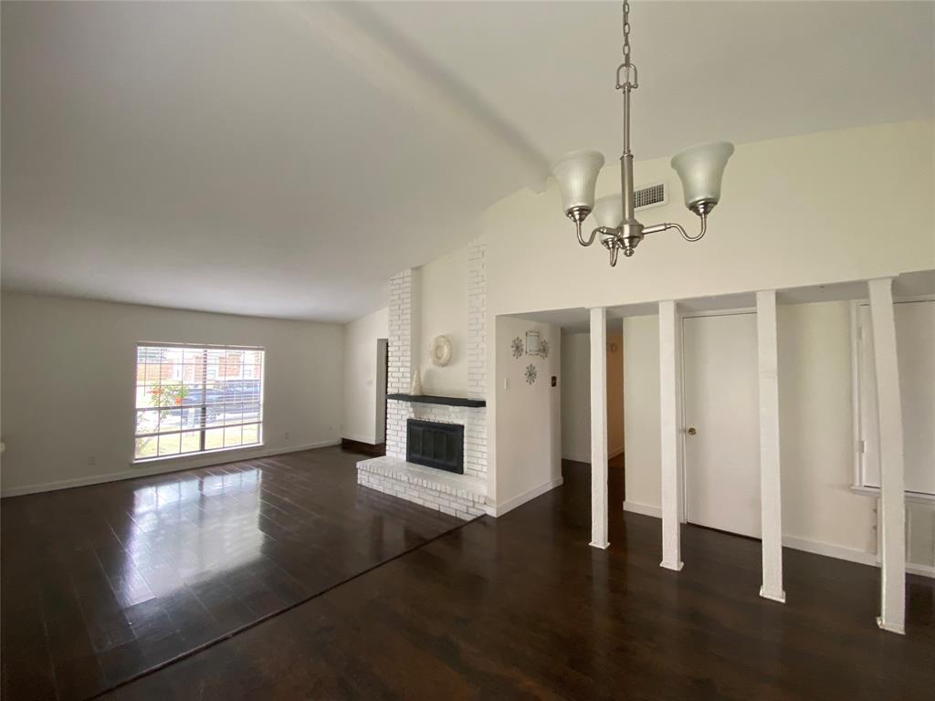 2018 Clark Trail Grand Prairie, TX 75052 - Photo 10 of 40 a view of a livingroom with wooden floor and a kitchen space
