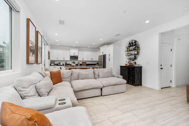 a living room with furniture and kitchen view