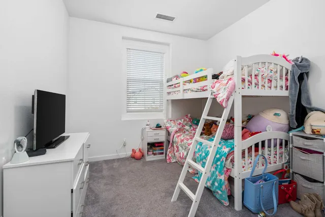 a room with furniture a flat screen tv and a baby crib
