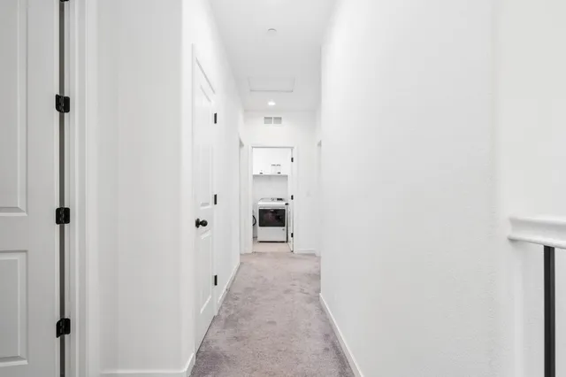 a view of a hallway with wooden shelves