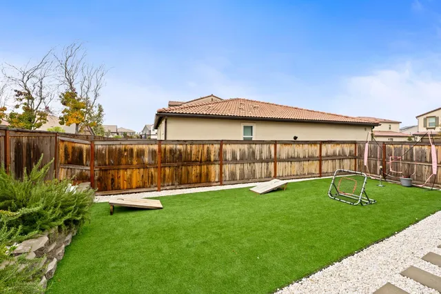 a view of a house with a yard and sitting area