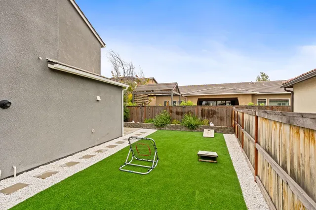 a view of a backyard with sitting area