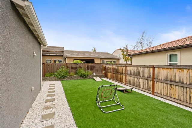 a view of a house with backyard and porch