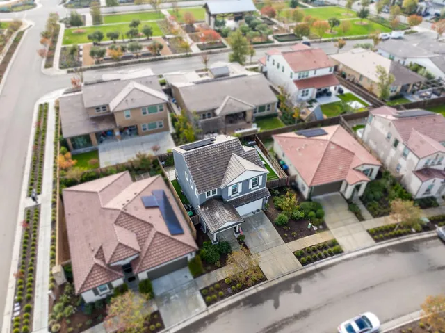 an aerial view of residential houses with outdoor space