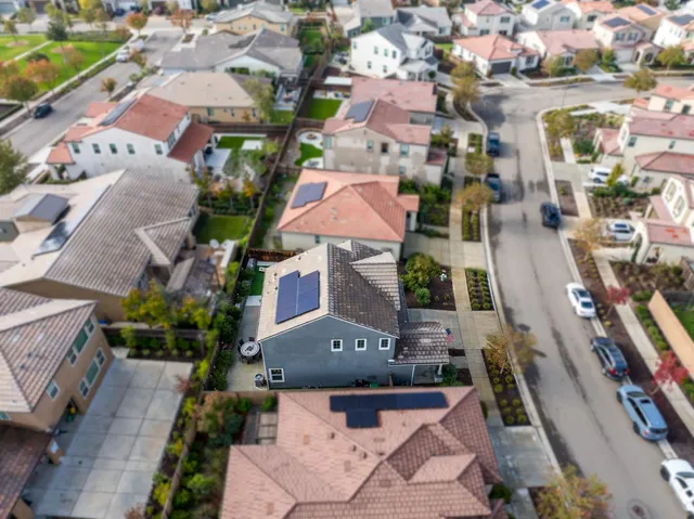 an aerial view of multiple houses with yard