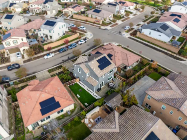 an aerial view of multiple houses with yard