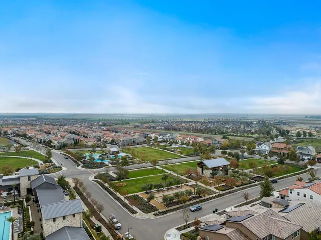 an aerial view of residential houses with outdoor space