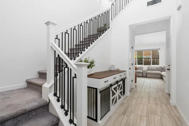 a view of entryway and hall with wooden floor