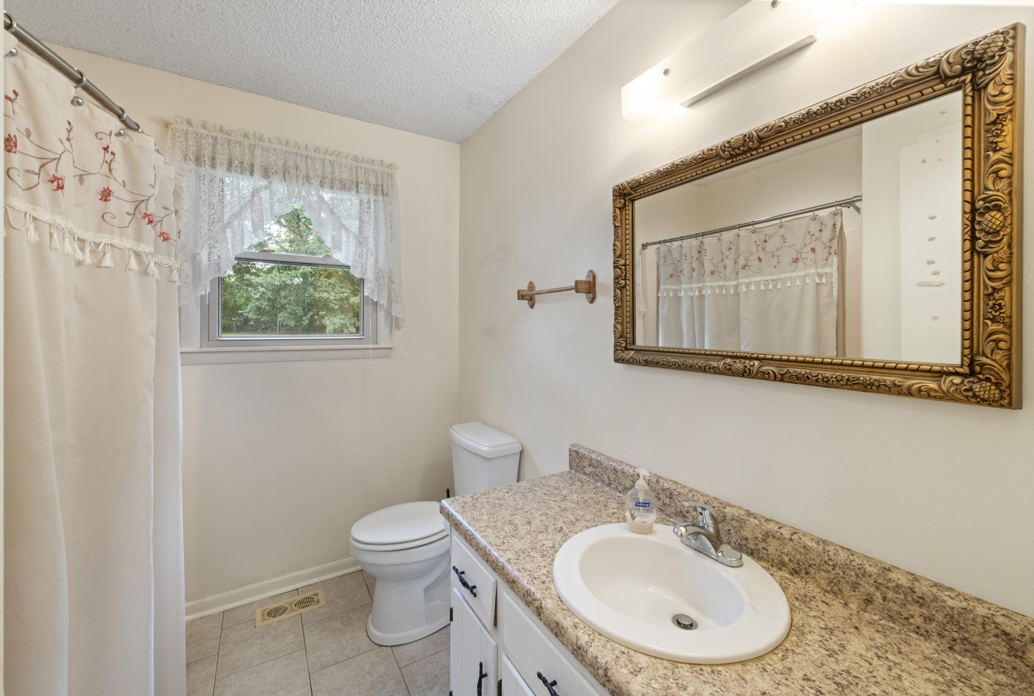 357 Raymond Hodges Road Cottontown, TN 37048 - Photo 11 of 21 a bathroom with a toilet a sink and mirror