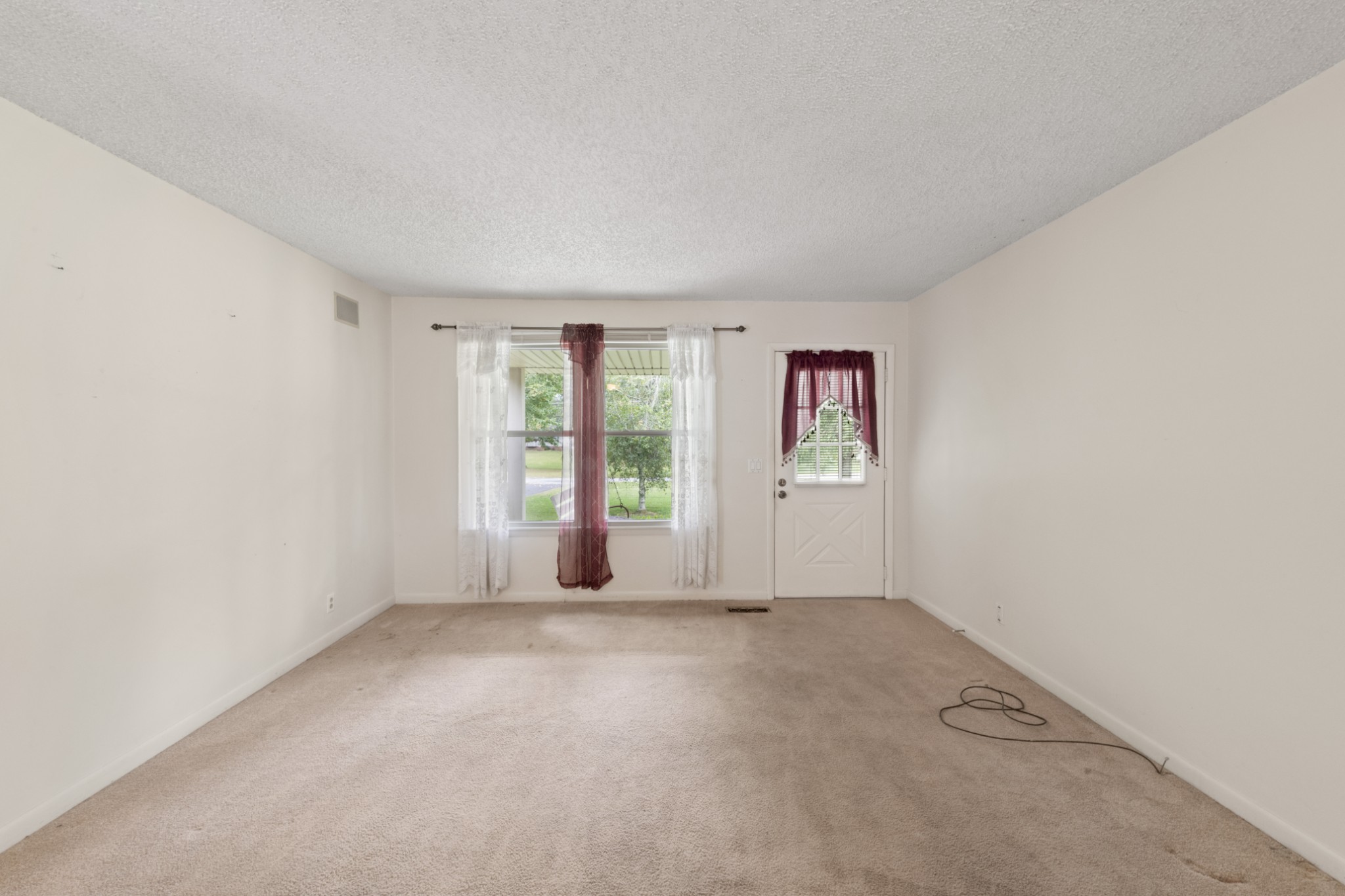357 Raymond Hodges Road Cottontown, TN 37048 - Photo 4 of 21 an empty room with windows