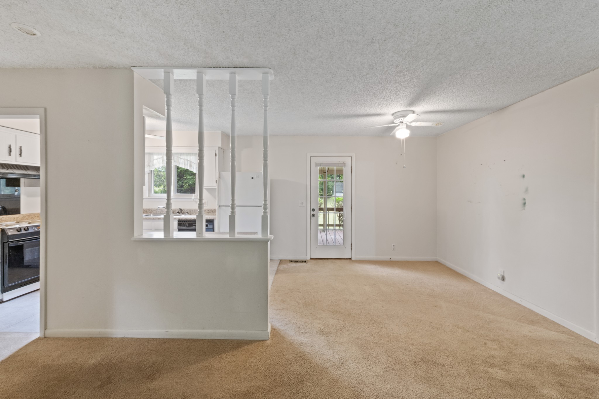 357 Raymond Hodges Road Cottontown, TN 37048 - Photo 5 of 21 an empty room with windows and chandelier fan