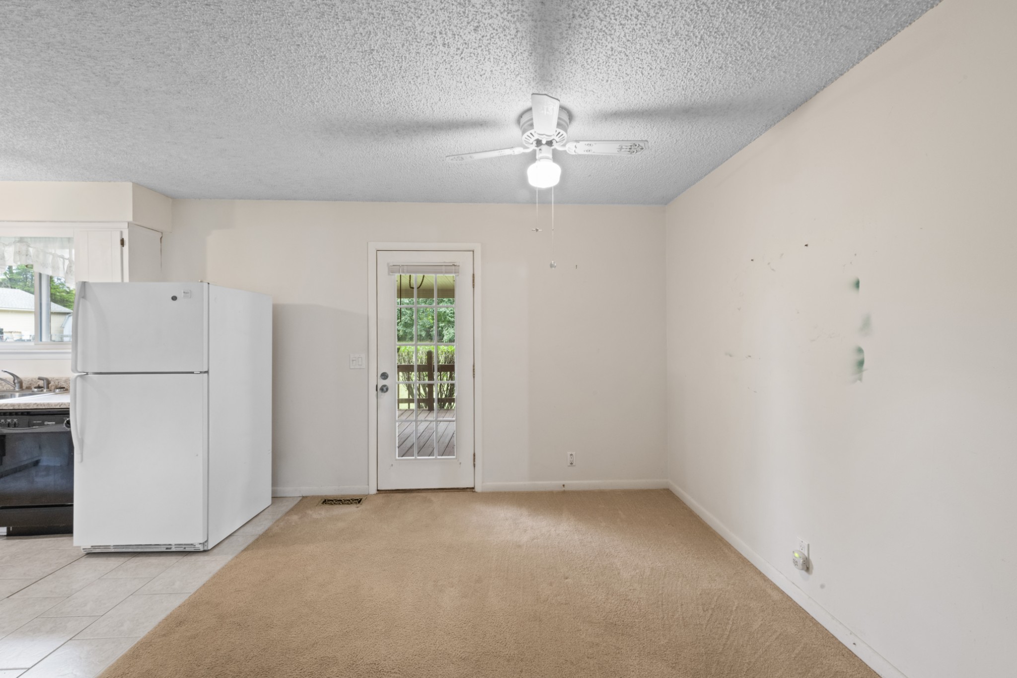 357 Raymond Hodges Road Cottontown, TN 37048 - Photo 7 of 21 an empty room with chandelier fan and windows