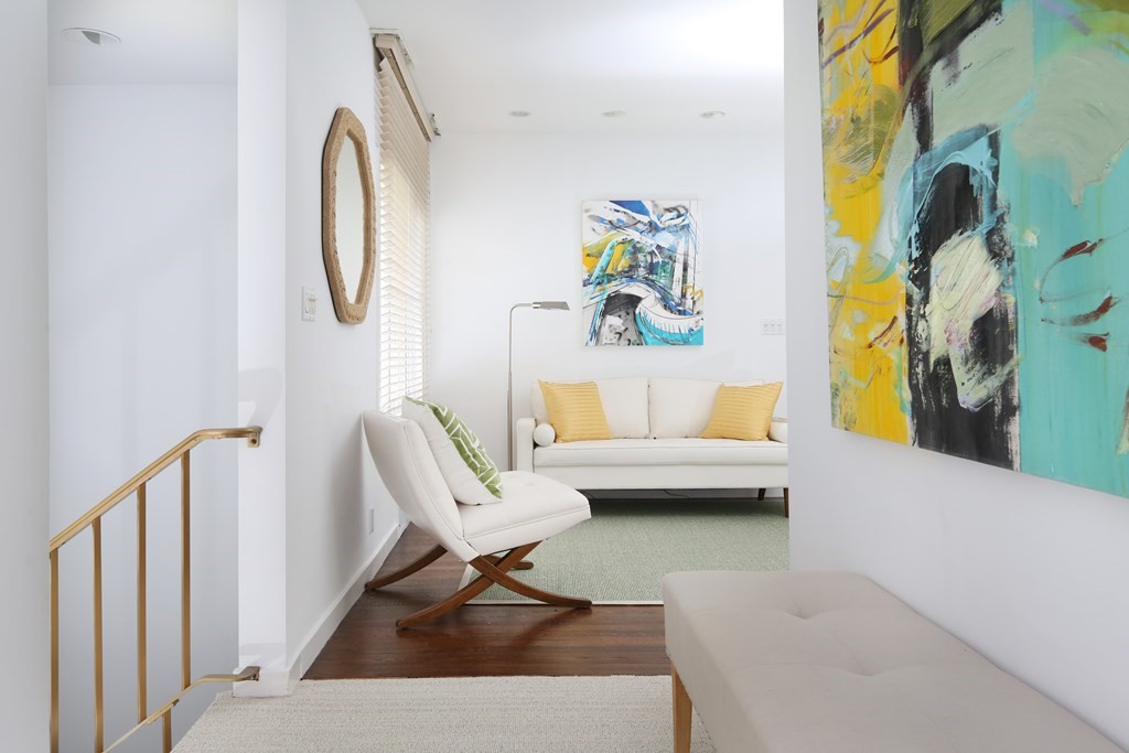 55 Chestnut Hill Road Newton, MA 02467 - Photo 10 of 21 a living room with a couch and a potted plant
