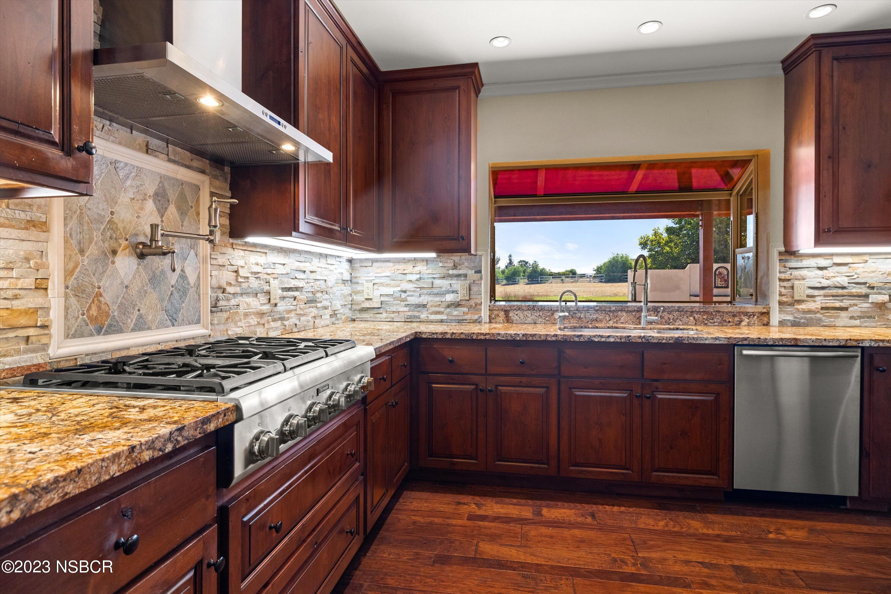 345 Meadowlark Road Santa Ynez, CA 93460 - Photo 13 of 57 a kitchen with stainless steel appliances granite countertop wooden cabinets and a stove top oven