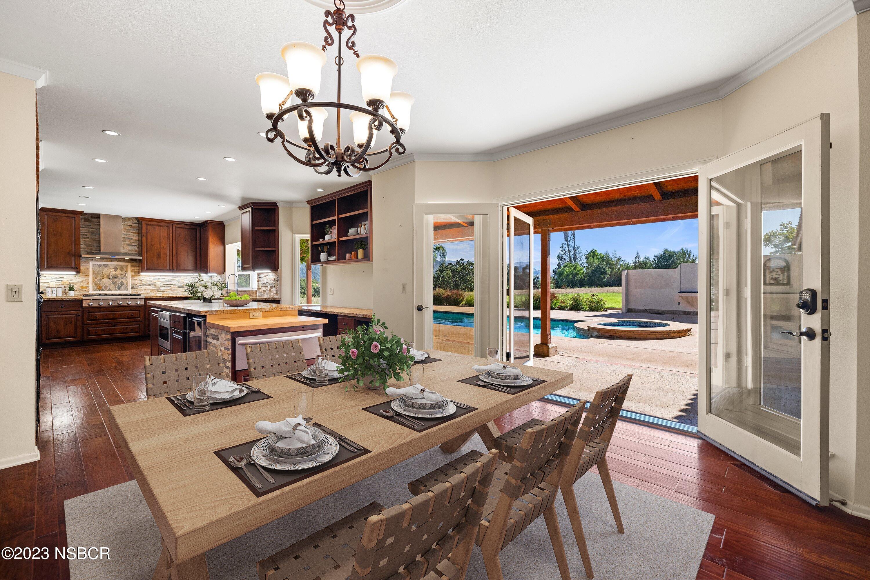 345 Meadowlark Road Santa Ynez, CA 93460 - Photo 16 of 57 a dining room with furniture a chandelier and wooden floor