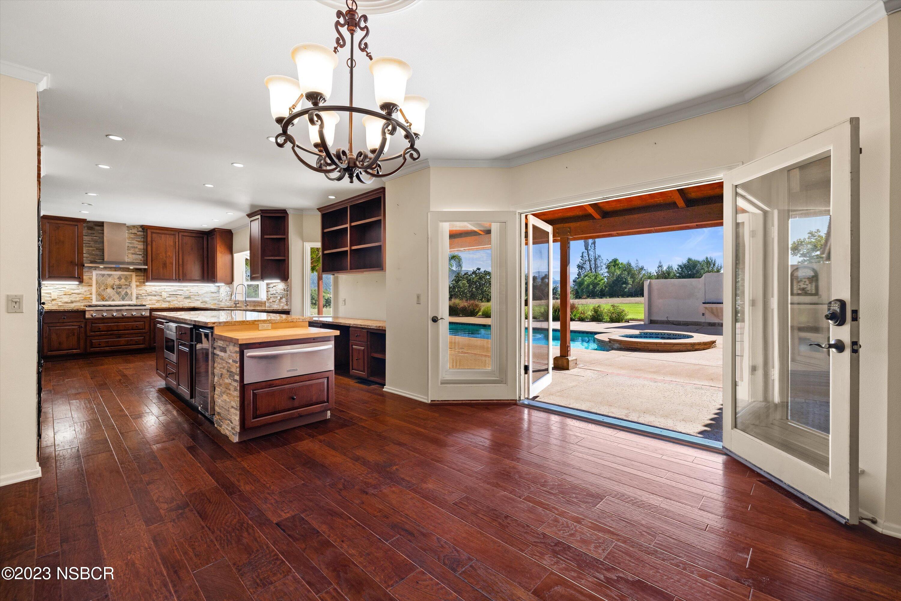 345 Meadowlark Road Santa Ynez, CA 93460 - Photo 17 of 57 a living room with stainless steel appliances kitchen island granite countertop wooden floors and wide window