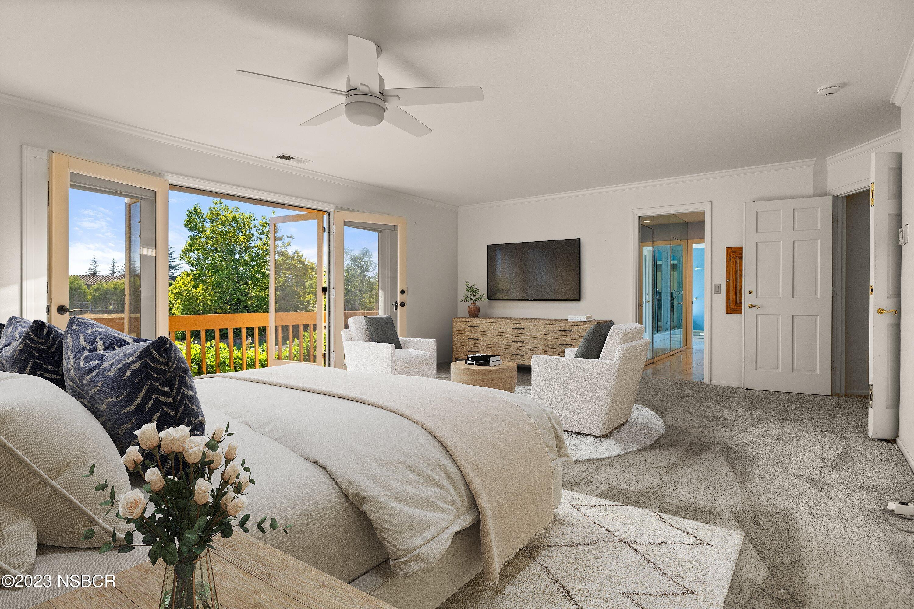 345 Meadowlark Road Santa Ynez, CA 93460 - Photo 20 of 57 a bedroom with a balcony a bed and a large window