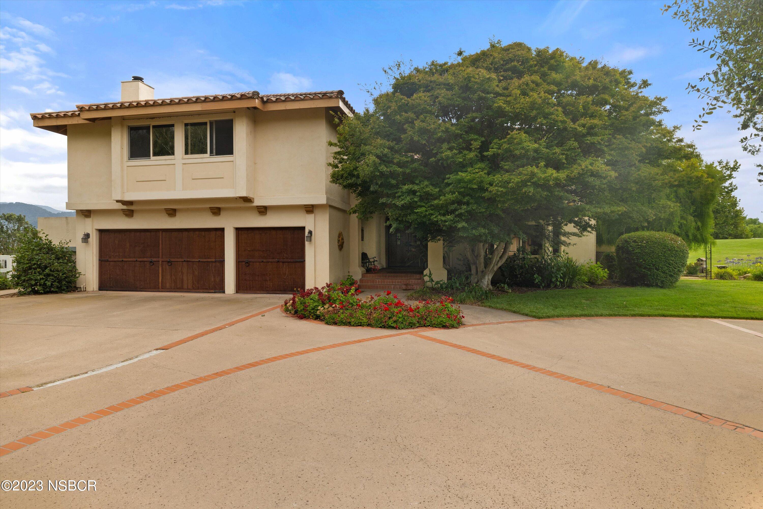 345 Meadowlark Road Santa Ynez, CA 93460 - Photo 2 of 57 a front view of a house with yard and trees