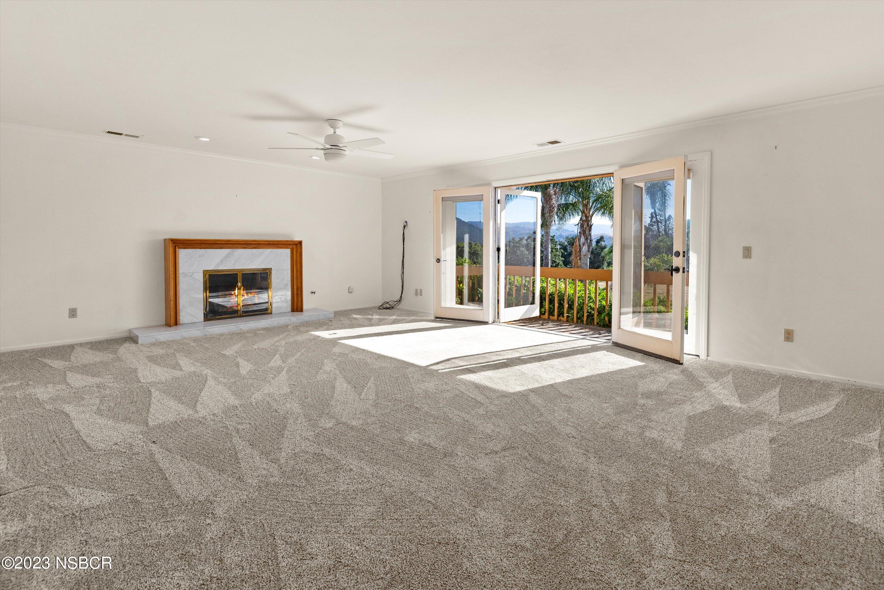 345 Meadowlark Road Santa Ynez, CA 93460 - Photo 22 of 57 an empty room with windows and fireplace