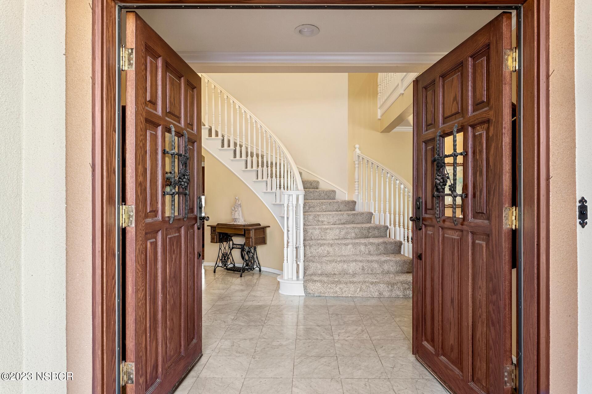 345 Meadowlark Road Santa Ynez, CA 93460 - Photo 3 of 57 a view of staircase with lots of frames on wall and a window