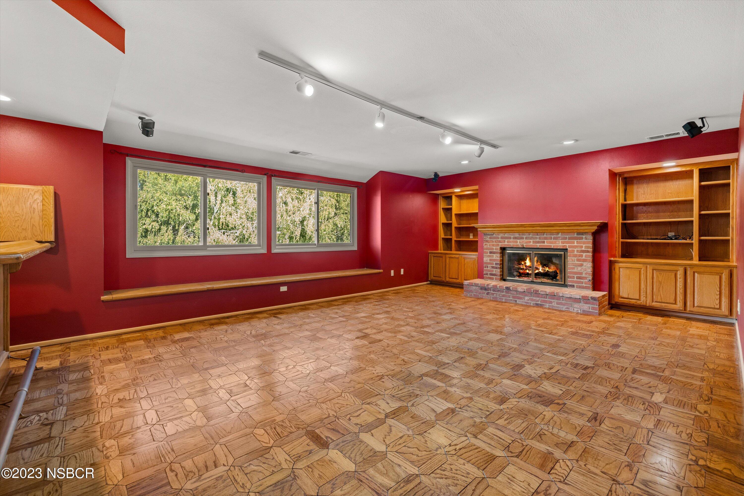 345 Meadowlark Road Santa Ynez, CA 93460 - Photo 31 of 57 a view of an empty room with a fireplace and a window