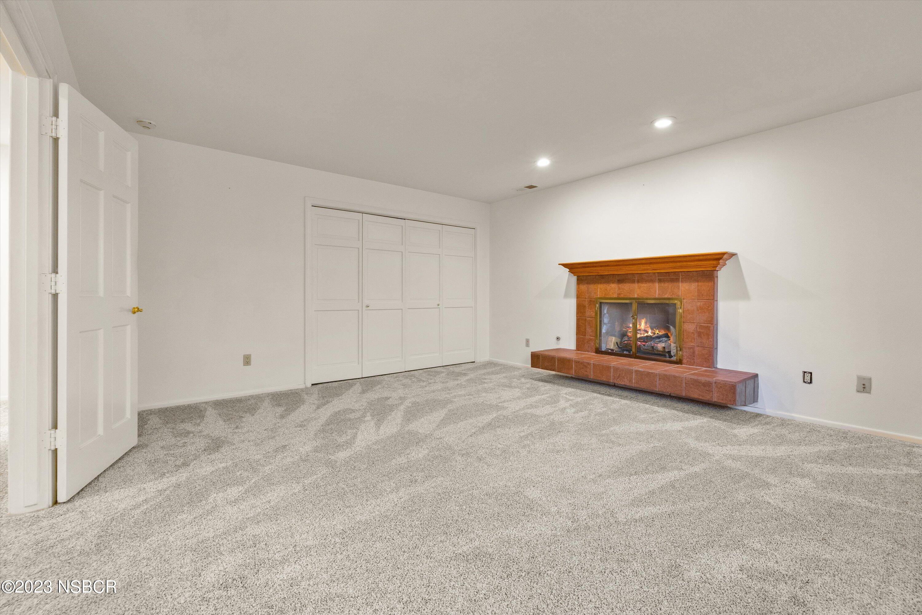 345 Meadowlark Road Santa Ynez, CA 93460 - Photo 36 of 57 a view of an empty room with a fireplace