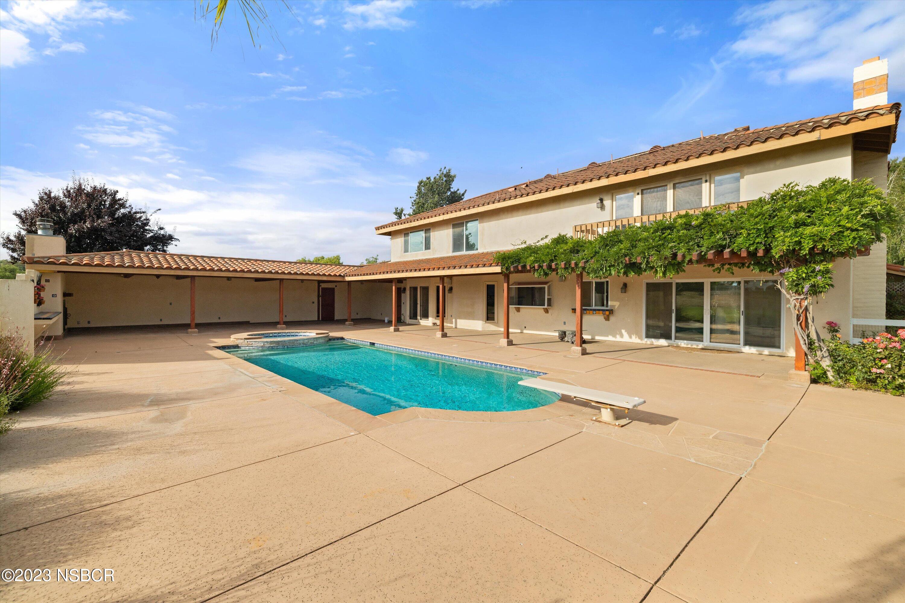 345 Meadowlark Road Santa Ynez, CA 93460 - Photo 40 of 57 a front view of a house with a yard and potted plants