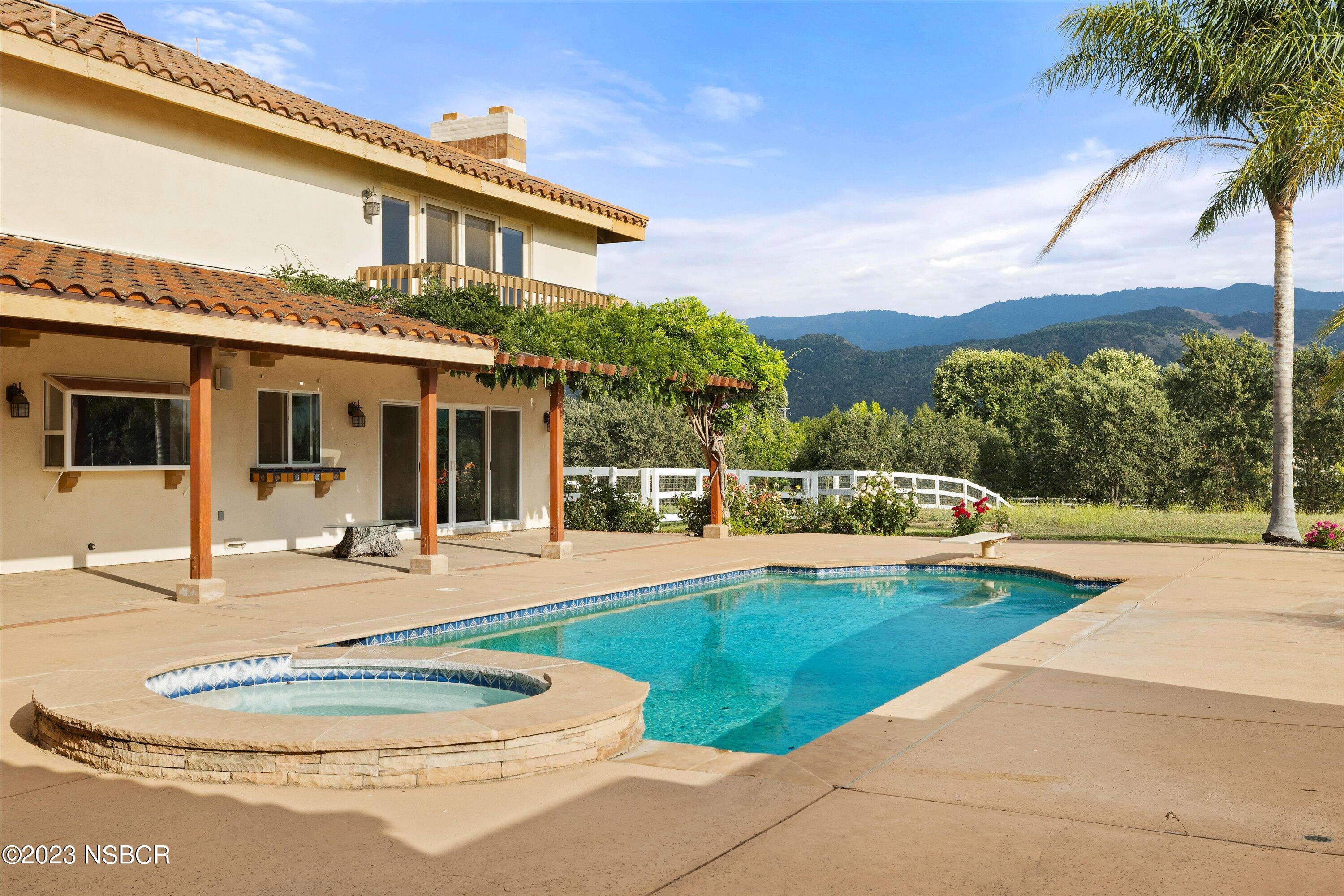 345 Meadowlark Road Santa Ynez, CA 93460 - Photo 41 of 57 a view of a house with swimming pool and a yard