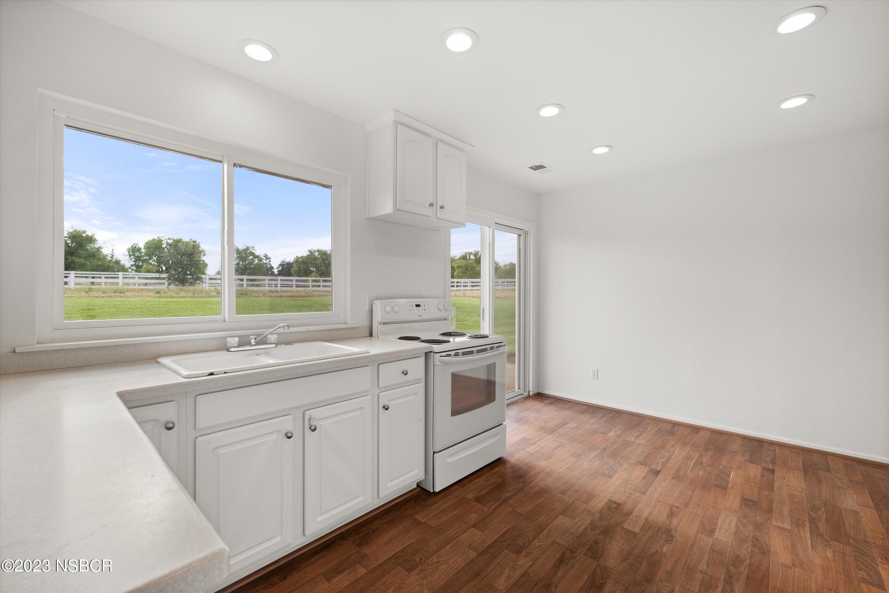 345 Meadowlark Road Santa Ynez, CA 93460 - Photo 50 of 57 a kitchen with a sink window and cabinets