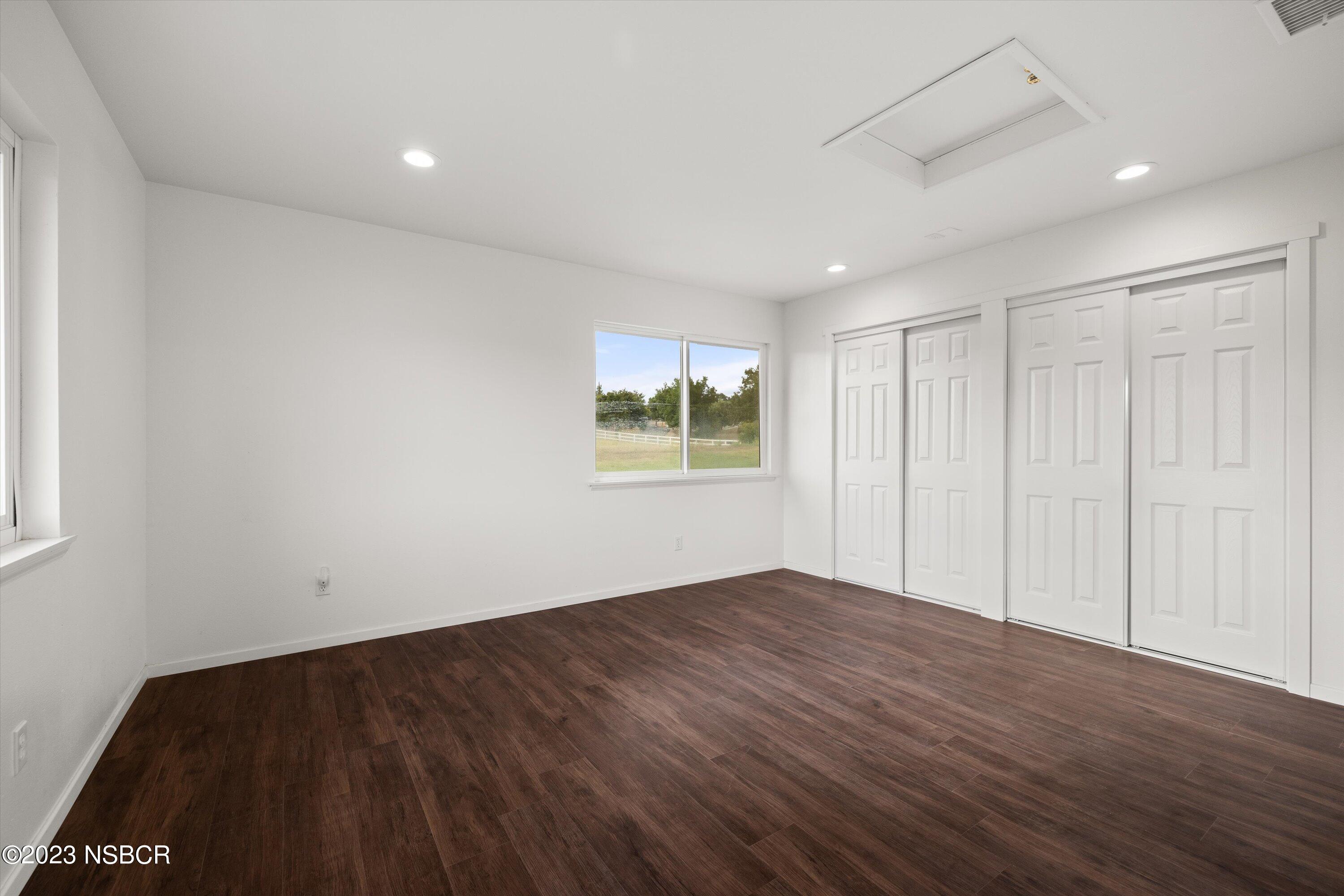 345 Meadowlark Road Santa Ynez, CA 93460 - Photo 52 of 57 a view of an empty room with wooden floor and a window