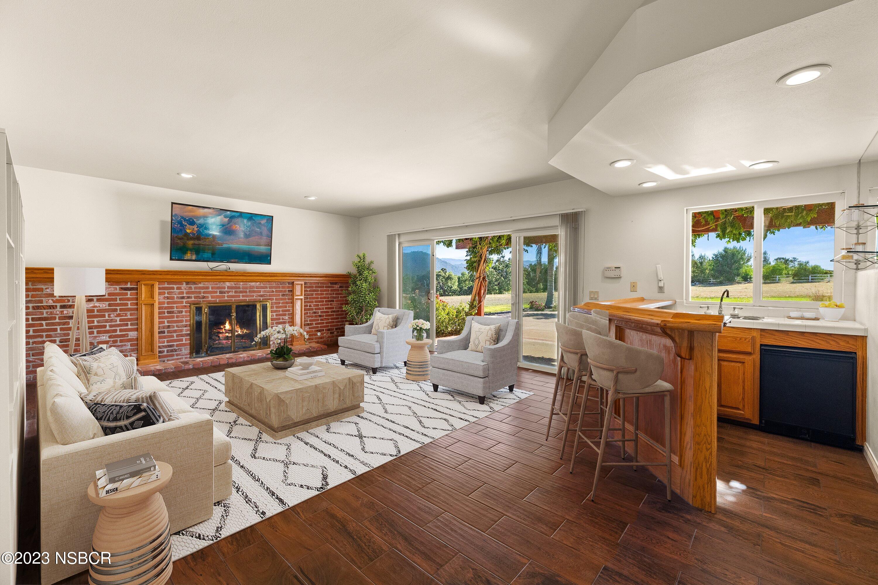 345 Meadowlark Road Santa Ynez, CA 93460 - Photo 10 of 57 a living room with furniture a large window and a fireplace