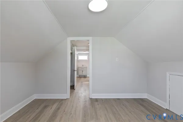 a view of a room with wooden floor a bathroom